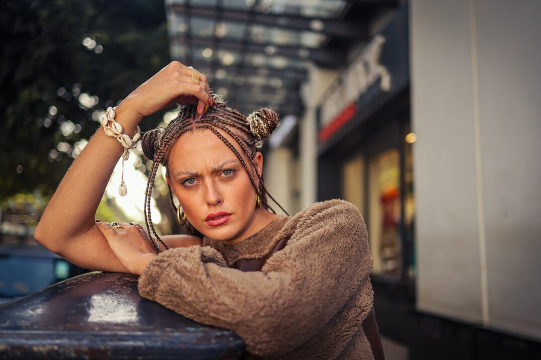 Woman with a warm expression and tied-back hair