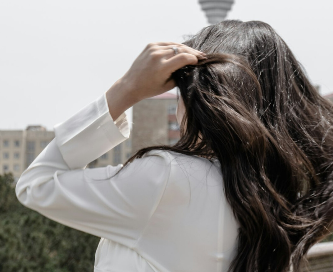 Smiling woman with long hair in a bright setting