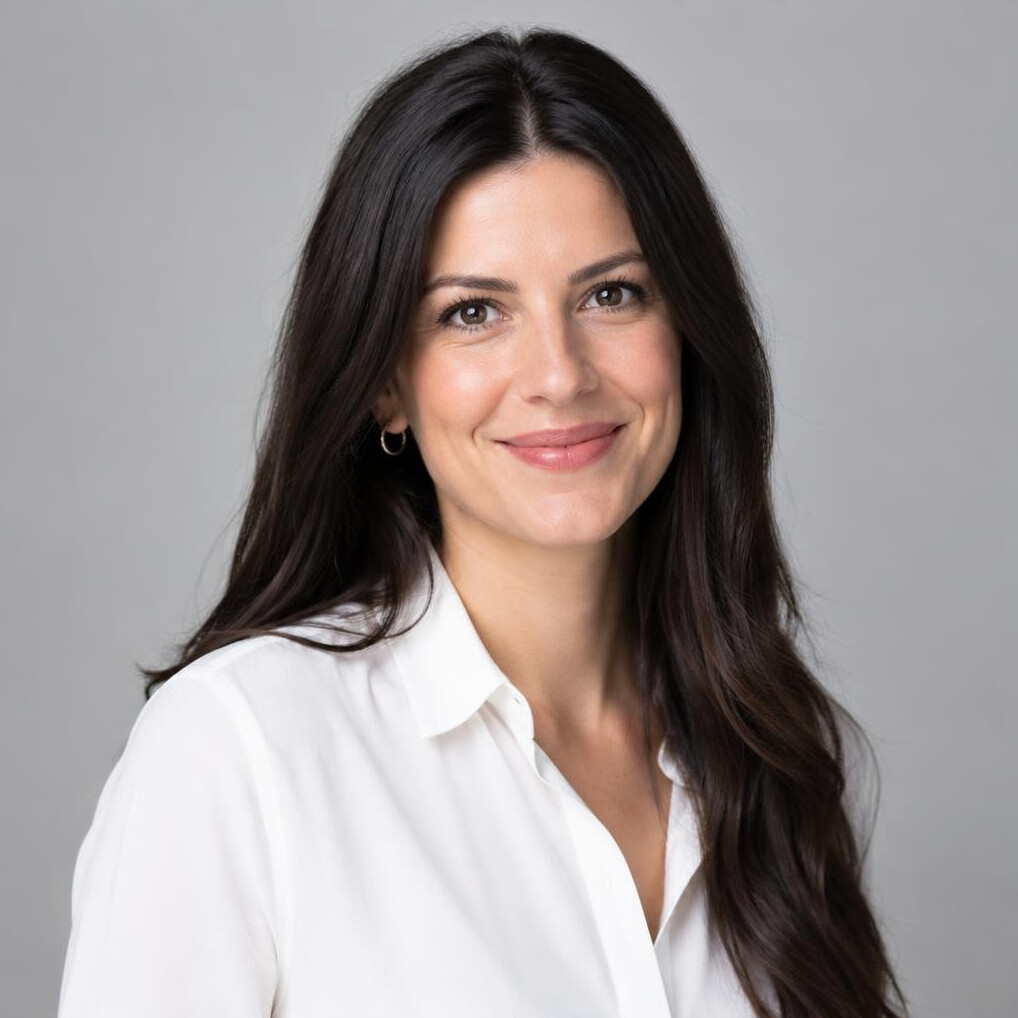 Woman with long dark hair smiling at the camera